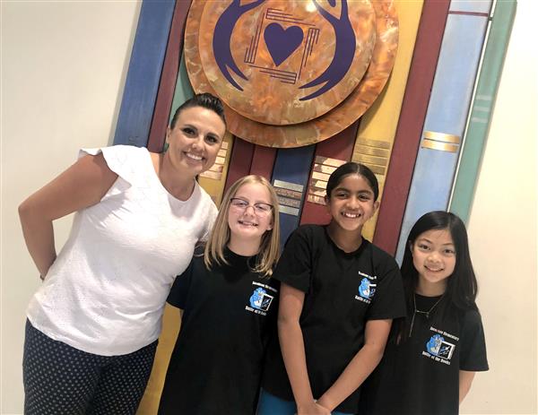 2021-2022 Battle of the Book semi-finalists are pictured here with Mrs. Estevez.  Ellie, Eva, and Amelia were know as the Bookworm Trio! 